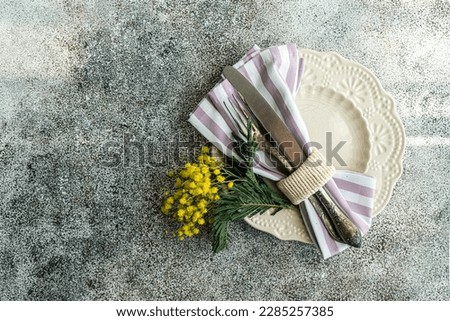 Easte dinner set with yellow mimosa flowers