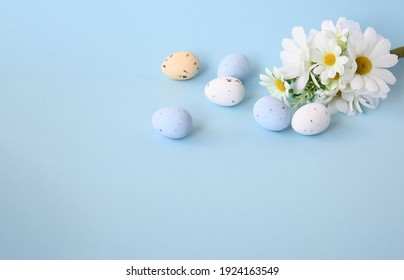 Easter background with bouquet white flwoer and easter eggs in soft color on blue sky background decorate and text copy space, happy and funny season in april