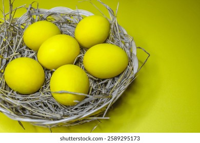 Easter background with bright yellow eggs, top view. Easter composition. Top view of yellow Easter eggs on the yellow background.