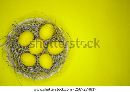 Easter background with bright yellow eggs, top view. Easter composition. Top view of yellow Easter eggs on the yellow background.