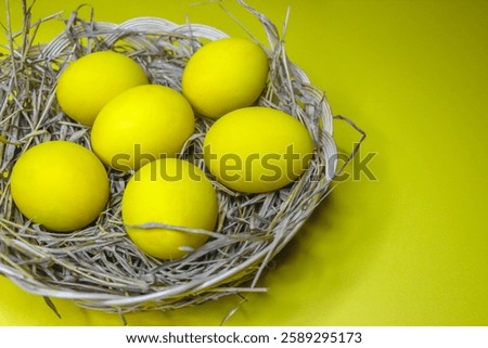 Easter background with bright yellow eggs, top view. Easter composition. Top view of yellow Easter eggs on the yellow background.