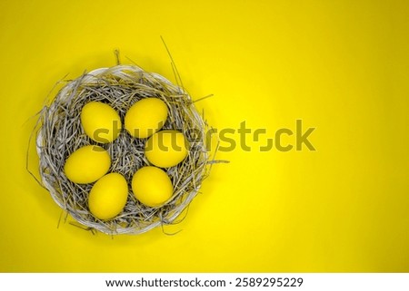 Easter background with bright yellow eggs, top view. Easter composition. Top view of yellow Easter eggs on the yellow background.