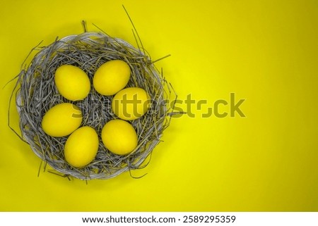 Easter background with bright yellow eggs, top view. Easter composition. Top view of yellow Easter eggs on the yellow background.