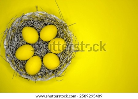 Easter background with bright yellow eggs, top view. Easter composition. Top view of yellow Easter eggs on the yellow background.