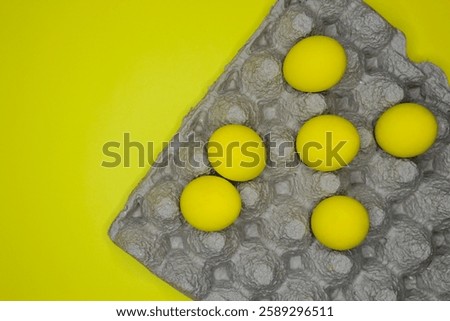 Easter background with bright yellow eggs, top view. Easter composition. Top view of yellow Easter eggs on the yellow background.