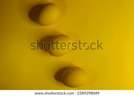 Easter background with bright yellow eggs. Easter composition. Top view of yellow Easter eggs on the yellow background.