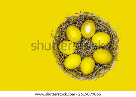 Easter background with bright yellow eggs, top view. Easter composition. Top view of yellow Easter eggs on the yellow background.