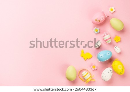 Easter background with colored eggs on pink. Top view image.
