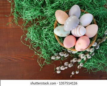 Easter background with Easter eggs in basket over green grass
