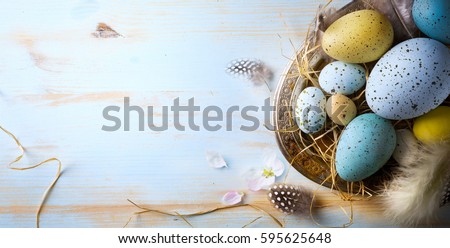 Easter background with Easter eggs and spring flowers. Top view with copy space.
