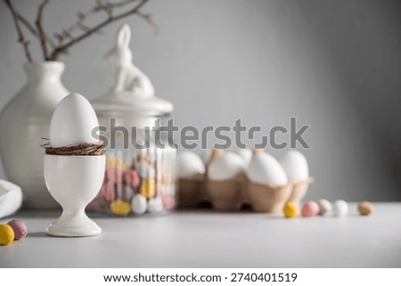  Easter background, table with spring decorations: eggs, candies, twigs in a vase and egg candies