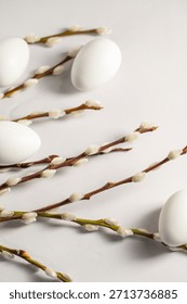 Easter background. Willow branches and white eggs. Spring time. Minimalistic and bright concept.