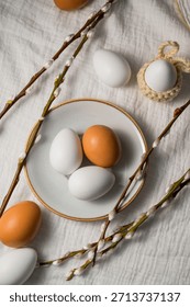 Easter background. Willow branches, white eggs in a plate. Spring time. Minimalistic top view