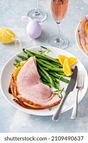 Easter Baked Ham Served On A Plate With Green Beans And Oranges