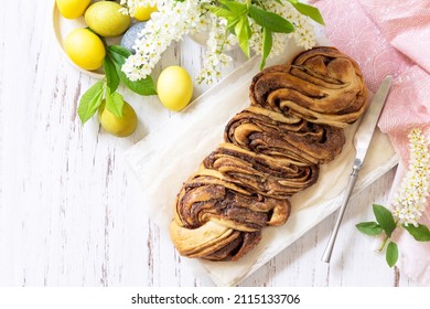 Easter Baking. Homemade Easter Chocolate Babka Or Brioche Bread. Sweet Yeast Dough With Chocolate Filling And Accompanied And Nuts On A Wooden Table. Top View Flat Lay Background. Copy Space.