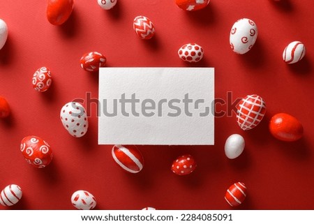 Easter banner with a blank sheet of paper and Easter red and white eggs on a bright red background.