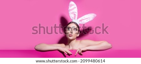 Easter banner with bunny woman. Easter young woman studio wearing bunny ears. curious isolated on pink.