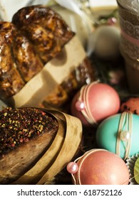 Easter basket for ceremony witn different food: Easter cake, colored eggs, jar with foie gras, sweets, homemade fried sausage, boiled pork, egg from white chocolate, laid on hay