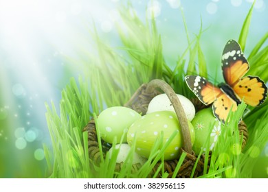  Easter basket with Easter eggs on spring background.