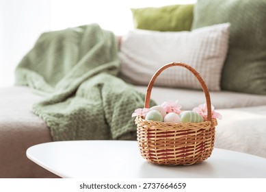 Easter Basket with Ester Eggs,  Plush Bunny and Spring Decor on White Table intoCozy Living Room