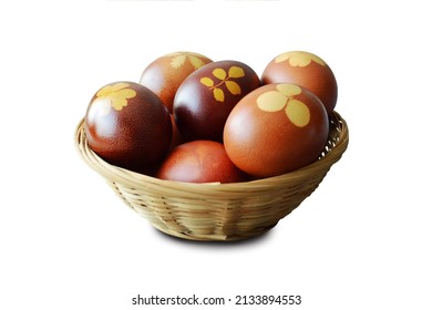 Easter basket with naturally dyed eggs with onion skins isolated on white background                                    