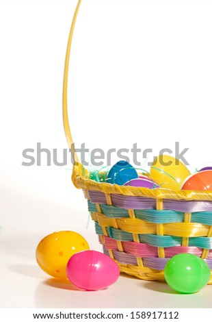 An Easter basket with plastic eggs isolated on white.