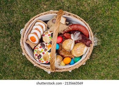 Easter Basket With Ukrainian Easter Cake, Cookies And Easter Eggs On Green Lawn, View From Above. Easter Item