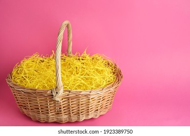 Easter Basket With Yellow Paper Filler On Pink Background, Space For Text