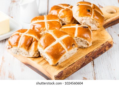 Easter Breakfast with Hot Cross Buns, served on Wooden Chopping Board, with Butter and Milk