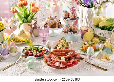 Easter breakfast with a plate of sliced ham, salami and sausages, fresh salads and stuffed eggs 