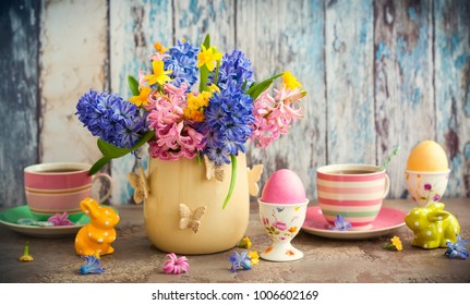 Easter Breakfast Table With Tea,eggs In Egg Cups, Spring Flowers In Vase And Easter Decor