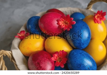 easter bright colored eggs in the easter egg basket. Festive Easter multicolored eggs on a wooden background.