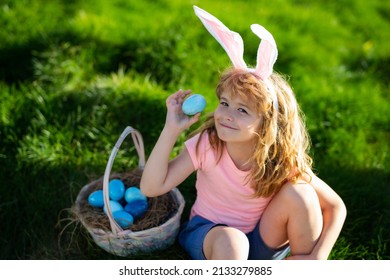 Easter Bunny Boy. Child In Bunny Ears Hunting Easter Eggs Outdoor On Backyard. Easter Egg Hunt.