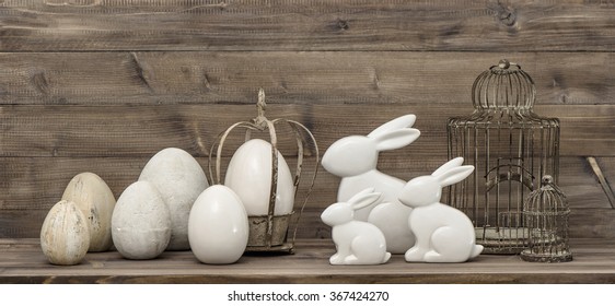 Easter Bunny And Easter Eggs Over Rustic Wooden Background. Vintage Decoration