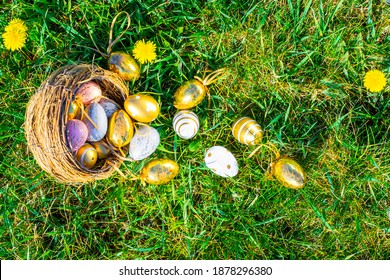 Easter Bunny. Golden Egg With Yellow Spring Flowers In Celebration Basket On Green Grass Background. Happy Easter Concept.