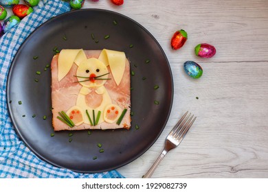 Easter Bunny Sandwich Made With Toast,ham,cheeses And Chives On Black Plate With White Wood Table Background.Idea For Easter Kids Meal.Top View With Copy Space