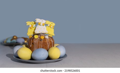 Easter cake decorated Colorful gingerbread bunnies with sugar icing and pastel blue and yellow Easter eggs. Easter traditions. Holiday concept with copy space.