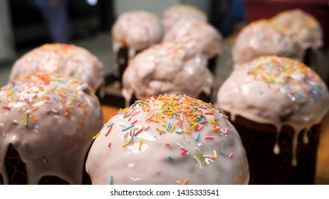 Easter Cake Decorated With White Sugar Glaze, Colorful Sugar Candy, Happy Easter Concept. Stock Footage. Close Up For Confectionery Sprinkles Falling In Slow Motion On The Cake.