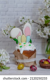 Easter cake dessert on the festive Easter table. Easter cake decorated with sugar icing and cookies in the shape of rabbit ears. Easter concept. selective focus