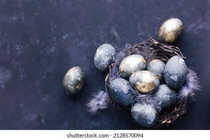 Easter card with a copy of the place for the text. Purple, blue and golden eggs on a dark background. The color trends of 2022  very peri. Natural dye Top view.