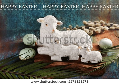 Easter card with a sheep cly figurine with two lambs lying on grunge background, eggs and Easter palm wish wishes text 