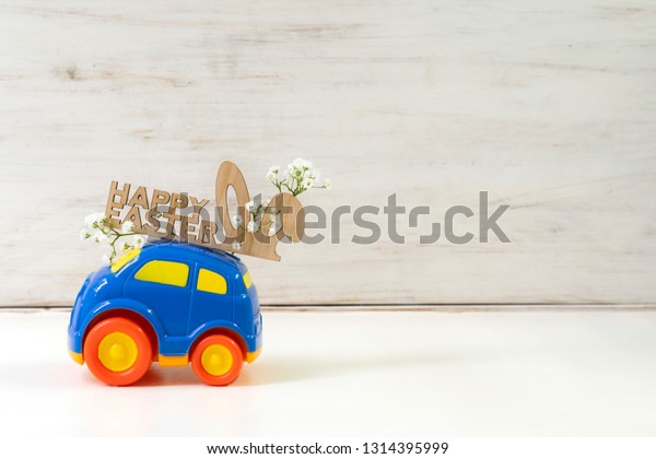 Easter cars with the\
words  \'\'Happy Easter\'\' on a white background, the concept of the\
approaching easter