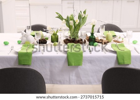 Easter celebration. Festive table setting with elegant dishware and flowers