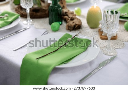 Easter celebration. Festive table setting with elegant dishware and willow branches, closeup