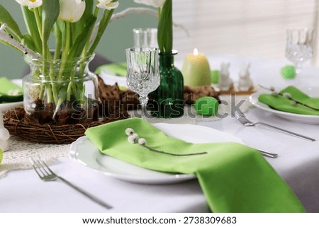 Easter celebration. Festive table setting with elegant dishware and willow branches, closeup