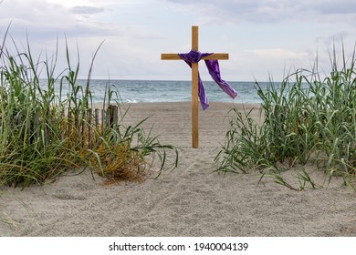 Easter celebration on the beach with cross and purple cloth