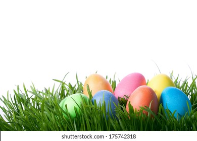 Easter Color Eggs On Green Grass Over White Background