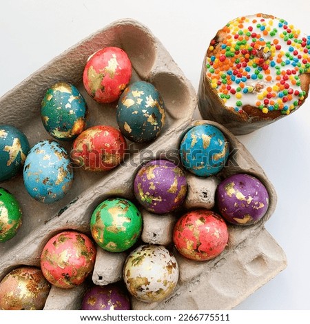 Easter colorful eggs covered with gold and Easter cake