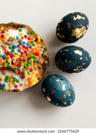 Easter colorful eggs covered with gold and Easter cake
