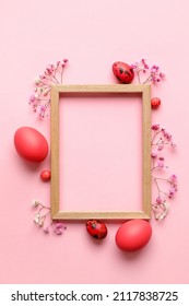 Easter composition with blank photo frame, eggs and flowers on pink background